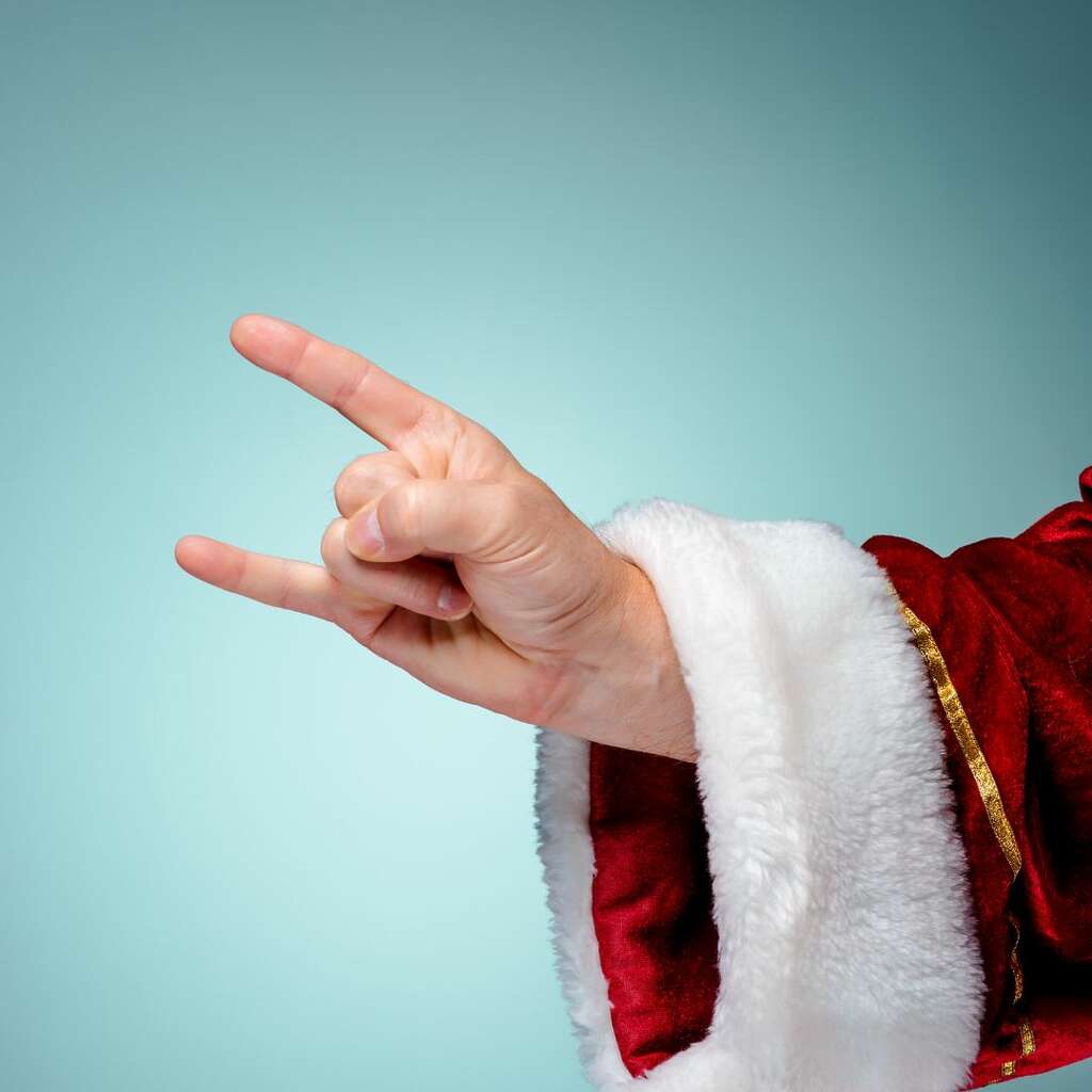 santa clause throwing up rock on fingers from his sleigh