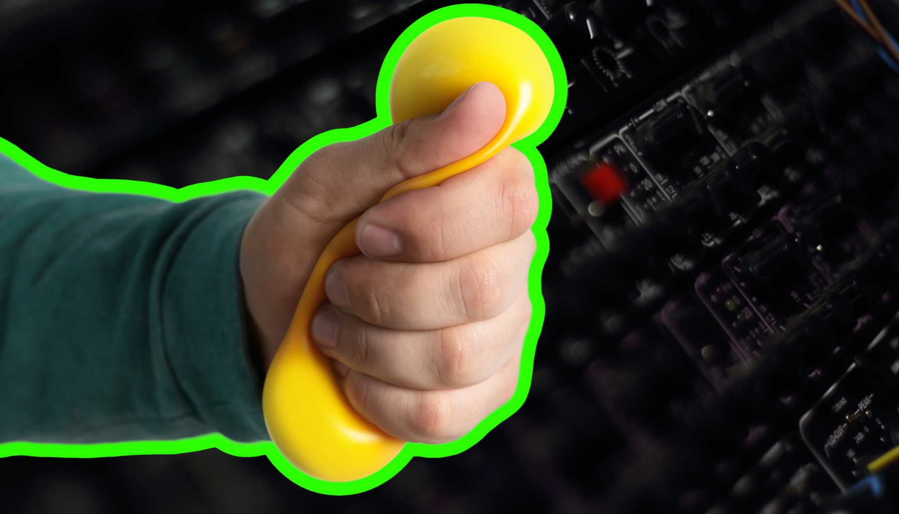 man squeezing a sponge compressing it in front of a rack of sophisticated audio equipment for audio recording and compression