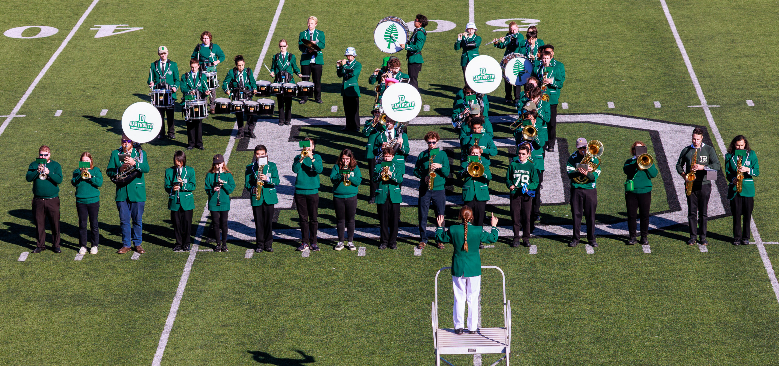 The Dartmouth College Marching Band performing on Memorial Field in Hanover, New Hampshire, in green and white uniforms
