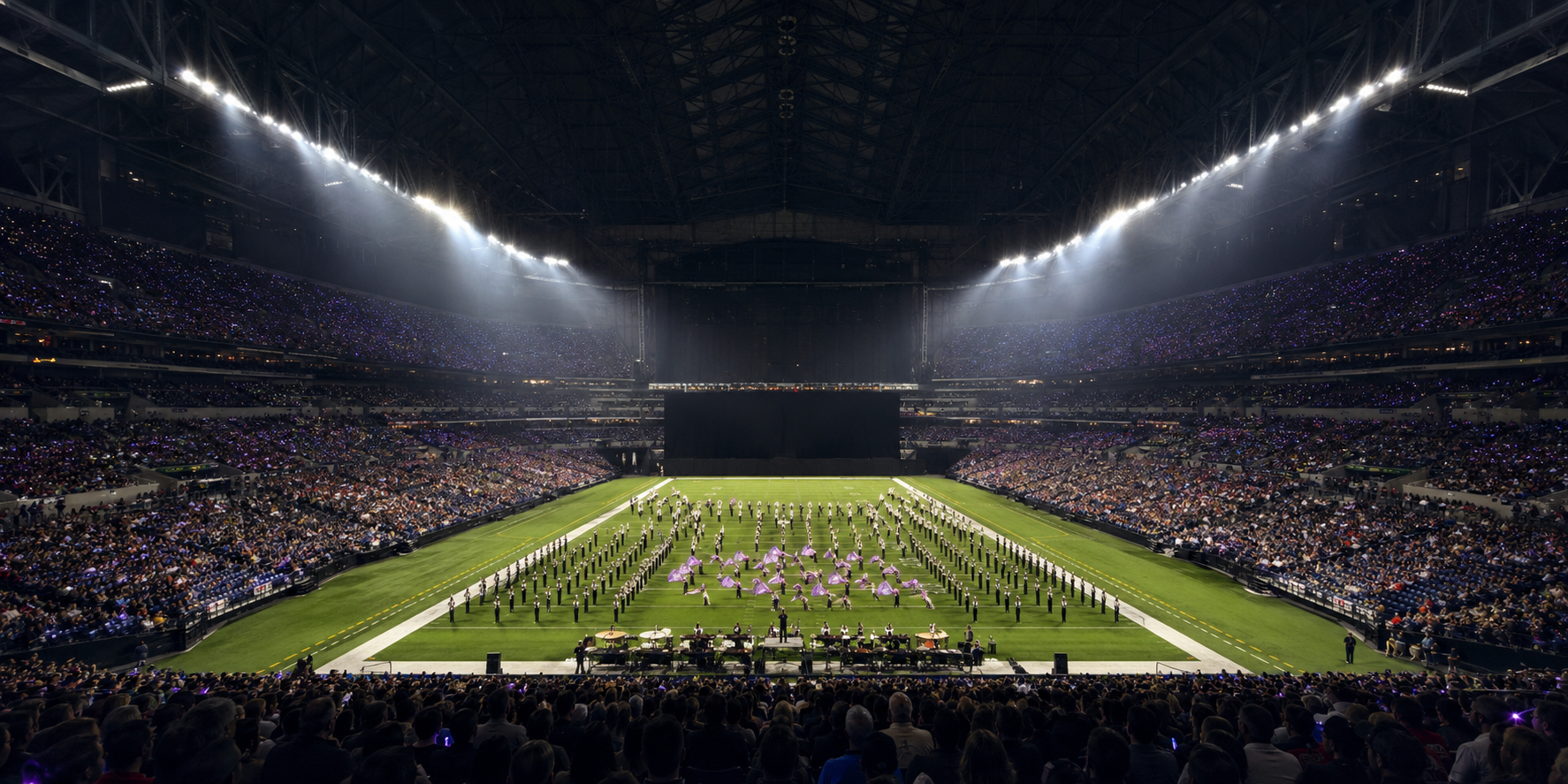 Wide cinematic view of Lucas Oil Stadium's domed interior at night during a marching band championship, full stands packed with band families and supporters, a band in mid-performance on the field below, light shafts visible from overhead stadium lighting