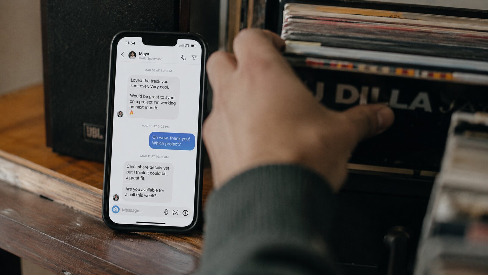 Hands packing music crowdfunding pledge rewards into kraft mailers